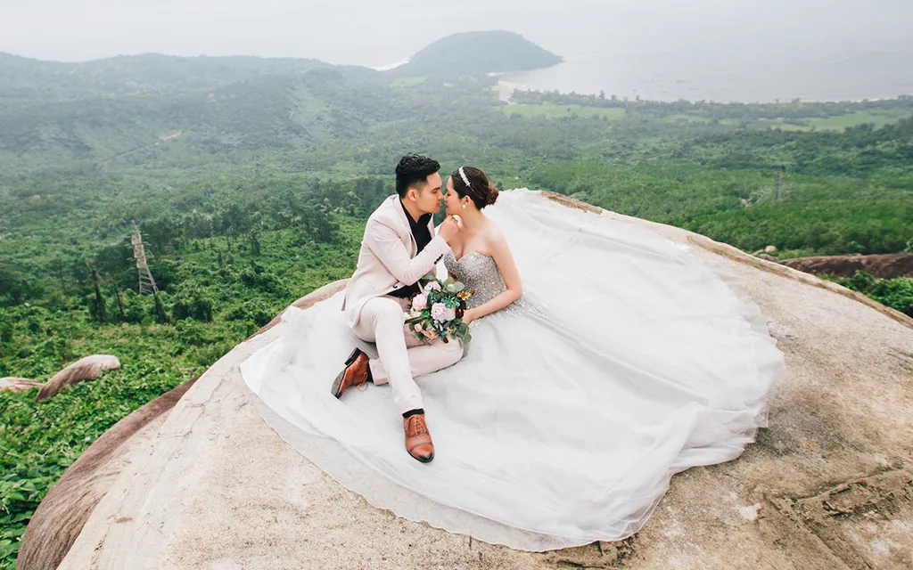 Newlywed couple embracing on a scenic cliff, representing a personal loan for a special event